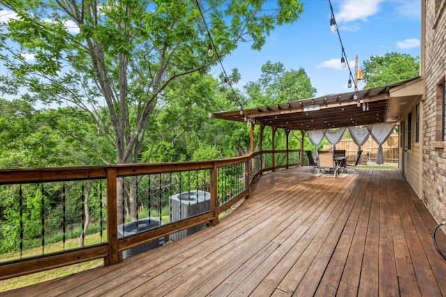 wooden terrace with outdoor dining area