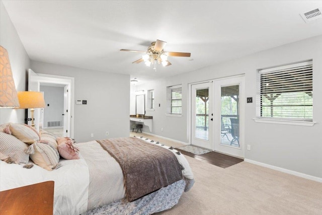 carpeted bedroom featuring access to outside, french doors, multiple windows, and visible vents