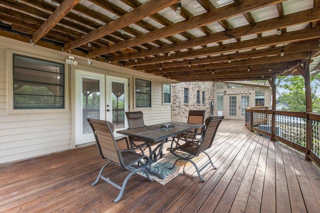 wooden terrace featuring outdoor dining area and french doors