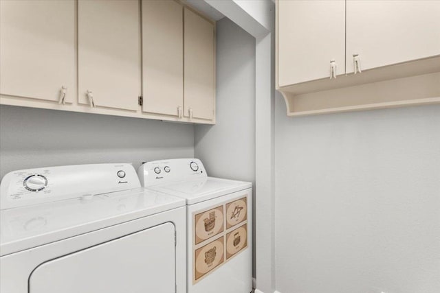 washroom featuring cabinet space and independent washer and dryer