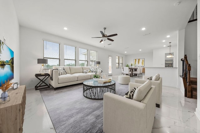 living room featuring recessed lighting, ceiling fan, baseboards, and marble finish floor