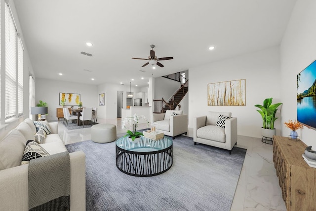 living area with ceiling fan, visible vents, stairway, marble finish floor, and recessed lighting