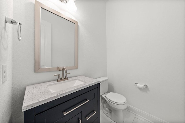 half bath with vanity, marble finish floor, baseboards, and toilet