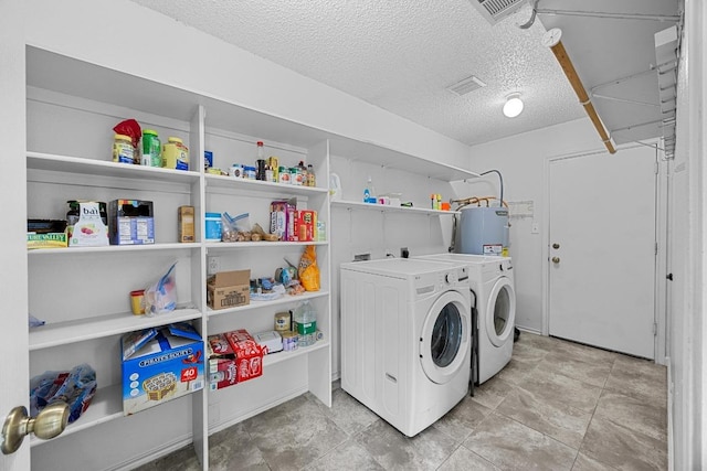 4325 Dos Cabezas Dr, Austin, TX 78749 - laundry area featuring water heater, a textured ceiling, and separate washer and dryer