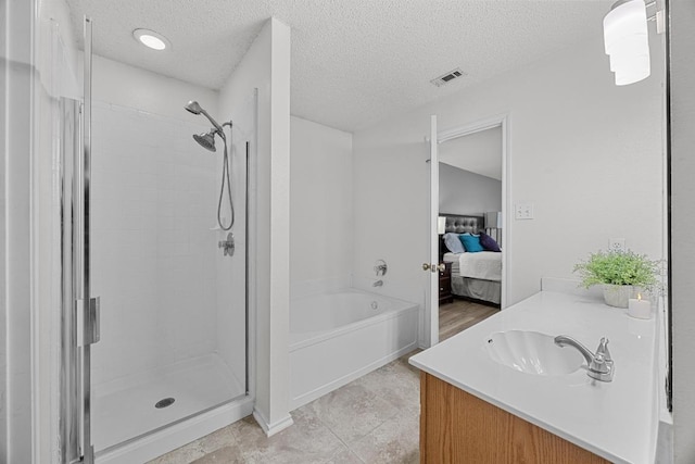 4325 Dos Cabezas Dr, Austin, TX 78749 - full bath with ensuite bathroom, a shower stall, a textured ceiling, vanity, and a garden tub
