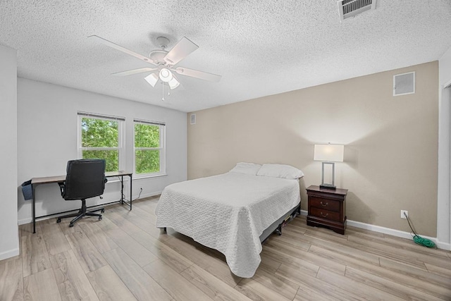 4325 Dos Cabezas Dr, Austin, TX 78749 - bedroom with light wood-style floors, a textured ceiling, baseboards, and ceiling fan