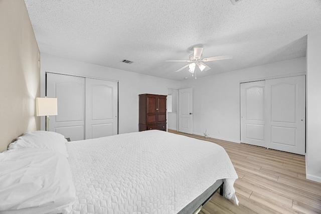 4325 Dos Cabezas Dr, Austin, TX 78749 - bedroom featuring light wood-style flooring, a textured ceiling, a ceiling fan, and baseboards