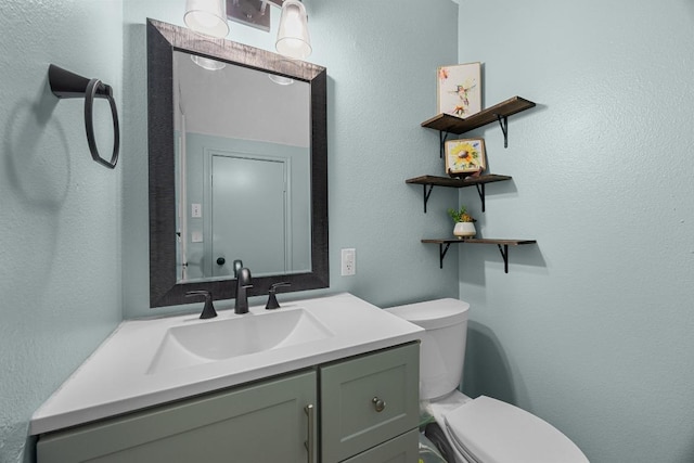 4325 Dos Cabezas Dr, Austin, TX 78749 - bathroom with toilet, vanity, and a textured wall