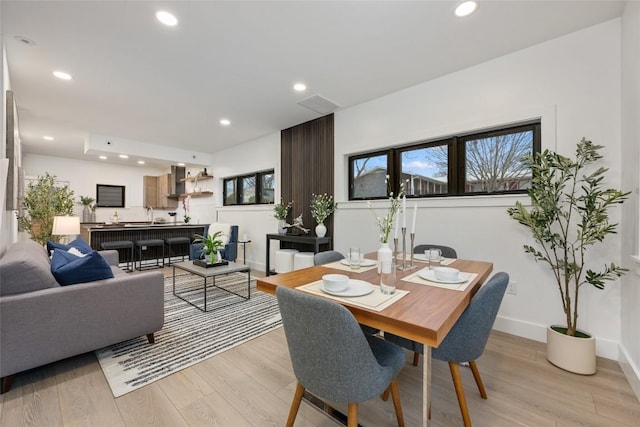 dining space featuring baseboards, recessed lighting, and light wood-style flooring