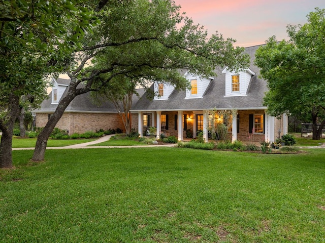 1350 Patterson Rd, Austin, TX 78733 - new england style home with a porch, brick siding, and a front yard