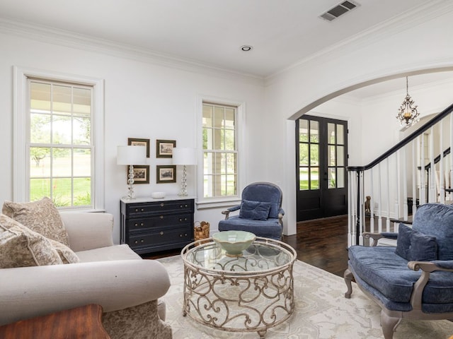 1350 Patterson Rd, Austin, TX 78733 - living area with arched walkways, stairs, wood finished floors, healthy amount of natural light, and ornamental molding