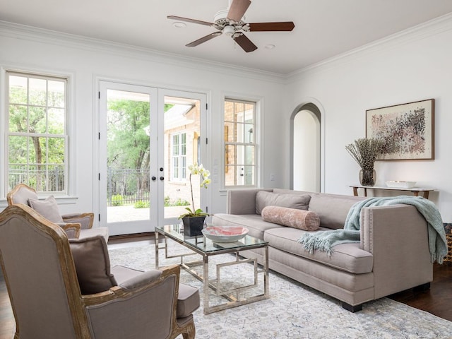 1350 Patterson Rd, Austin, TX 78733 - living room featuring wood finished floors, crown molding, ceiling fan, healthy amount of natural light, and arched walkways
