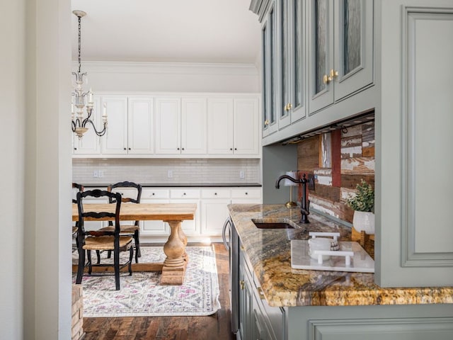 1350 Patterson Rd, Austin, TX 78733 - kitchen featuring tasteful backsplash, dark wood-style floors, dark stone countertops, a chandelier, and white cabinetry