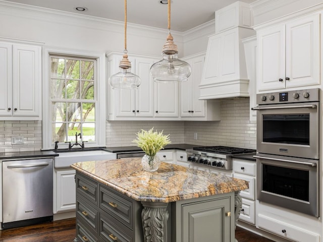 kitchen featuring a sink, appliances with stainless steel finishes, and white cabinets