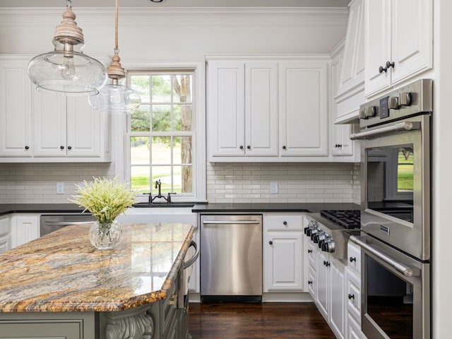 1350 Patterson Rd, Austin, TX 78733 - kitchen with stainless steel appliances, decorative backsplash, white cabinets, dark wood-style flooring, and ornamental molding