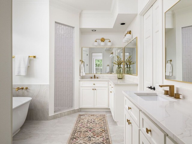 1350 Patterson Rd, Austin, TX 78733 - bathroom featuring two vanities, crown molding, a soaking tub, and tiled shower