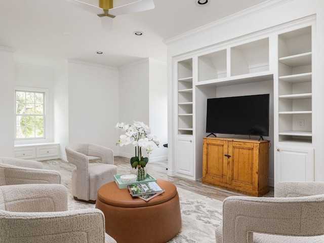 living room featuring a ceiling fan, crown molding, built in features, baseboards, and light wood finished floors