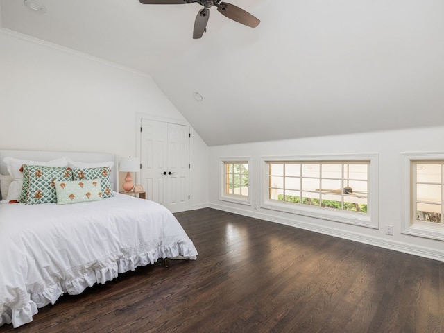bedroom with crown molding, lofted ceiling, wood finished floors, baseboards, and ceiling fan
