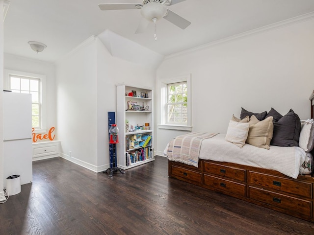 bedroom with crown molding, freestanding refrigerator, and dark wood-style flooring