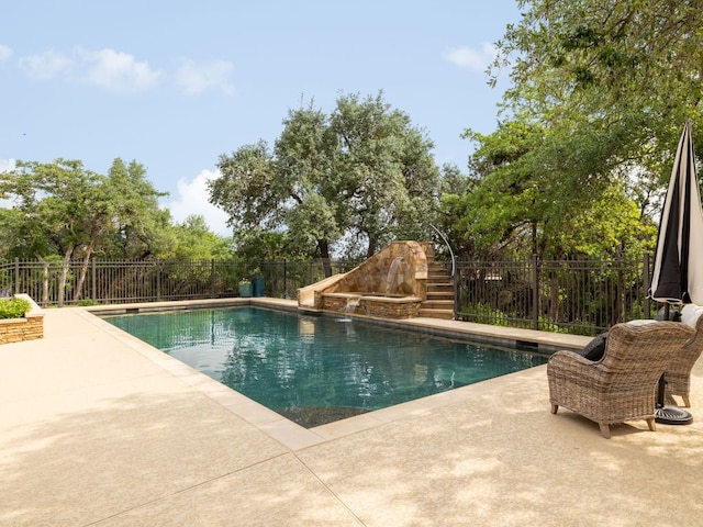 view of swimming pool featuring a fenced in pool, fence, and a patio