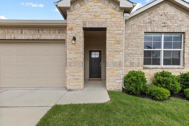view of exterior entry with an attached garage, stone siding, and concrete driveway