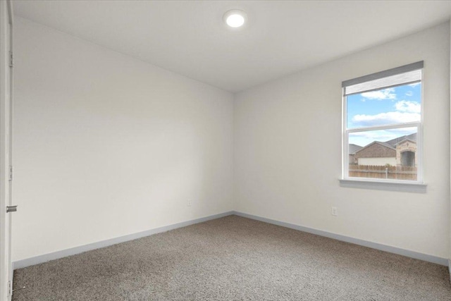 empty room with baseboards and carpet floors