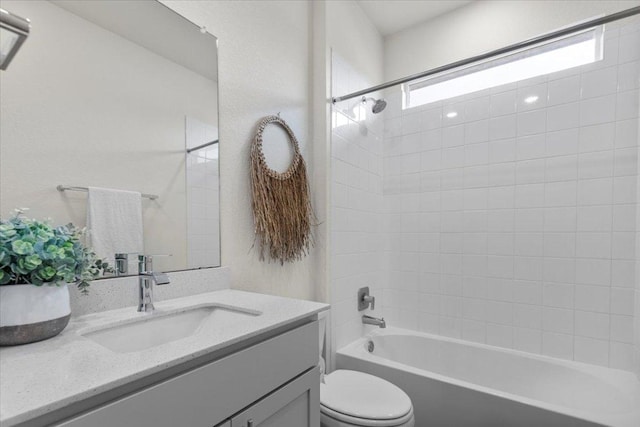 bathroom with vanity, toilet, and shower / washtub combination