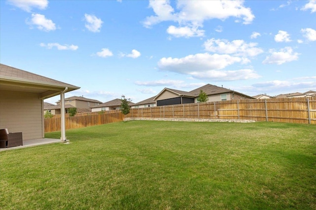 view of yard with a fenced backyard, a patio area, and a residential view
