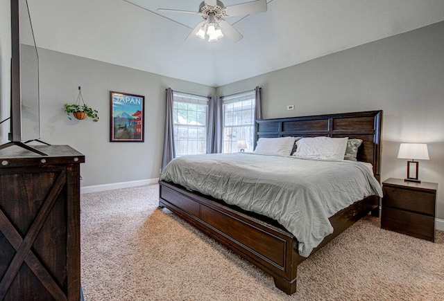 carpeted bedroom with baseboards, ceiling fan, and vaulted ceiling