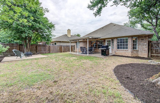 view of yard featuring a fenced backyard, a patio area, and an outdoor fire pit