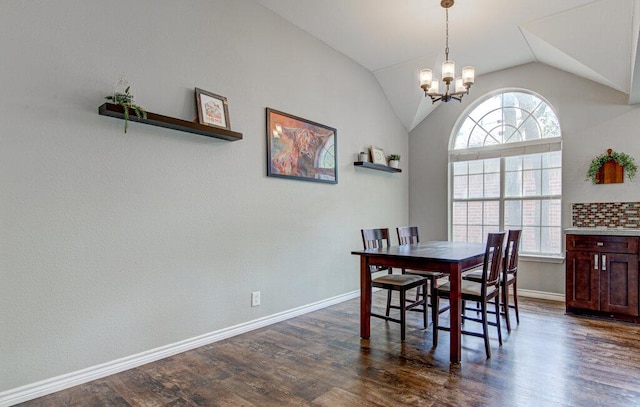 dining area featuring an inviting chandelier, baseboards, vaulted ceiling, and dark wood-style flooring