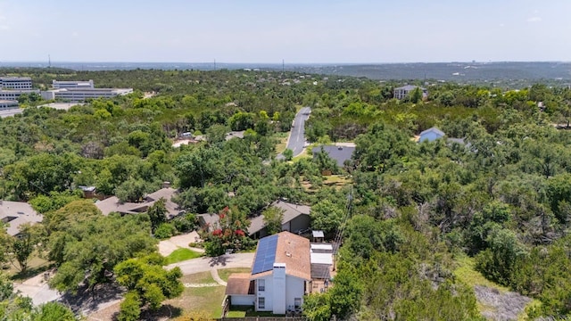 bird's eye view featuring a wooded view