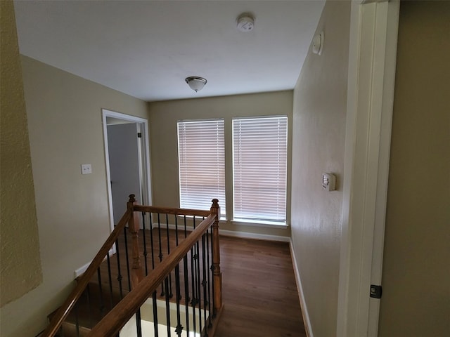 stairway with baseboards and wood finished floors