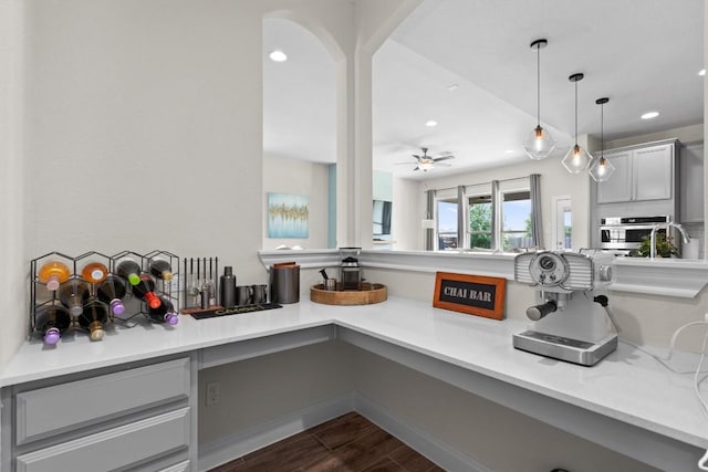 17111 Calipatria Ln, Pflugerville, TX 78660 - kitchen with stainless steel oven, dark wood finished floors, recessed lighting, light countertops, and ceiling fan
