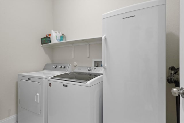 clothes washing area with laundry area and washer and dryer