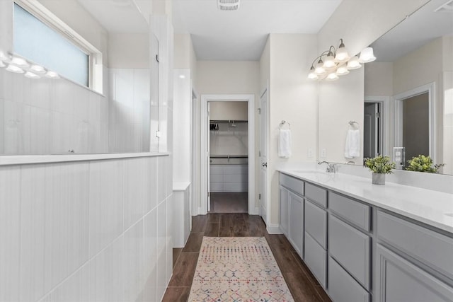 17111 Calipatria Ln, Pflugerville, TX 78660 - bathroom featuring vanity, walk in shower, wood finished floors, and a spacious closet