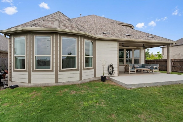 rear view of house featuring ceiling fan, fence, a patio, an outdoor hangout area, and a lawn