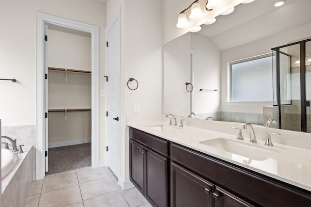 full bath with a sink, a garden tub, a shower stall, and double vanity