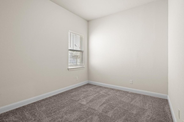 carpeted spare room with baseboards