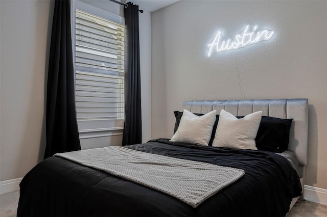 bedroom featuring baseboards and carpet flooring