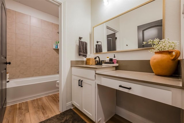 full bathroom with toilet, tub / shower combination, wood finished floors, and vanity