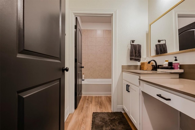 full bath with vanity, shower / bath combination, and wood finished floors