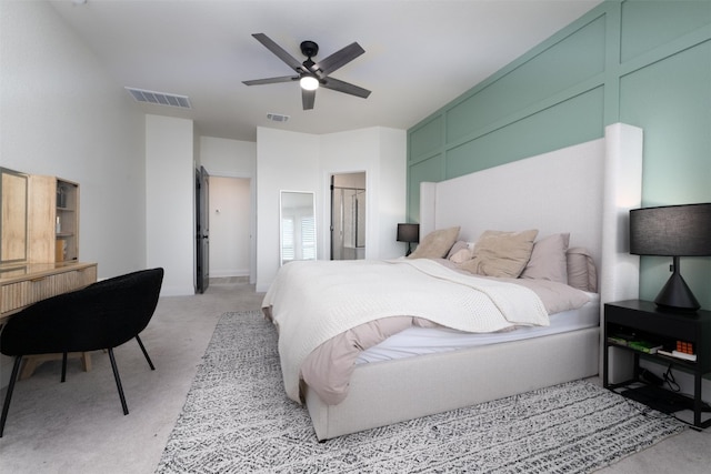 bedroom featuring a ceiling fan, visible vents, and light carpet