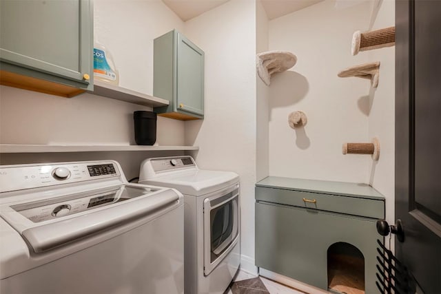 clothes washing area with cabinet space, washer and clothes dryer, and tile patterned flooring