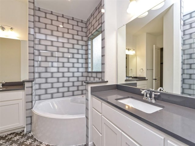 bathroom with a garden tub, a sink, and two vanities