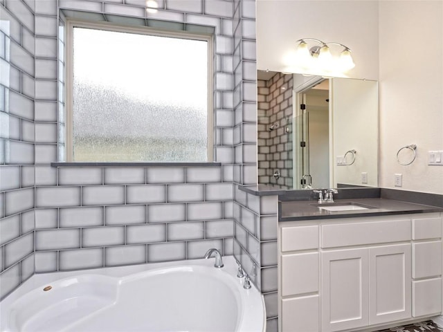 full bathroom featuring vanity and a bath