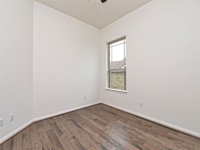 spare room featuring baseboards, ceiling fan, and wood finished floors
