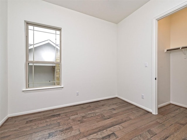 unfurnished room featuring baseboards and wood finished floors