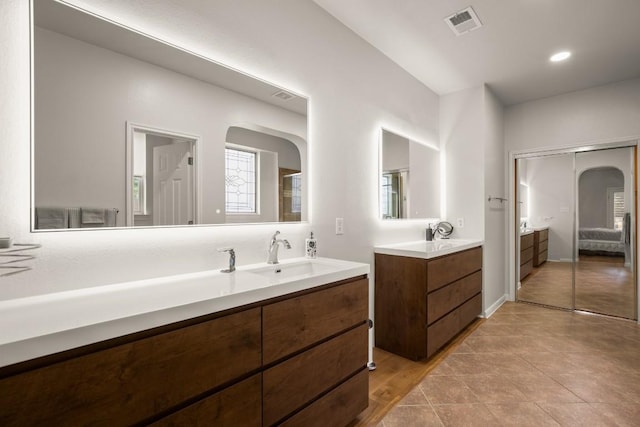715 Nelson Ranch Rd, Cedar Park, TX 78613 - bathroom with tile patterned floors, visible vents, two vanities, and a sink