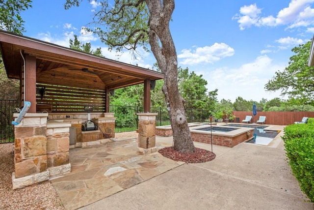 715 Nelson Ranch Rd, Cedar Park, TX 78613 - view of patio featuring a gazebo, a fenced backyard, an in ground hot tub, and exterior kitchen